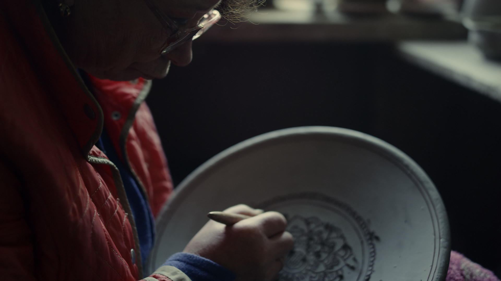 在陶器制品上做装饰品的老妇人视频的预览图