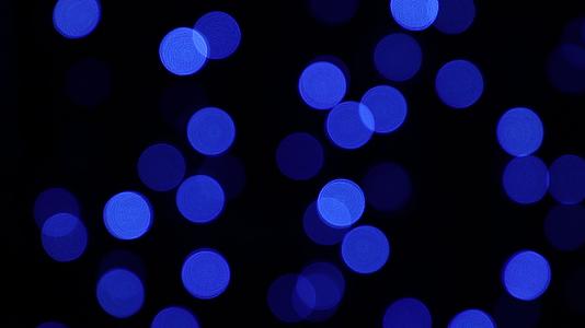 蓝色的节日灯在黑暗的背景上闪耀视频的预览图