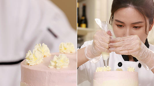 蛋糕师在蛋糕顶上挤奶油花装饰视频的预览图