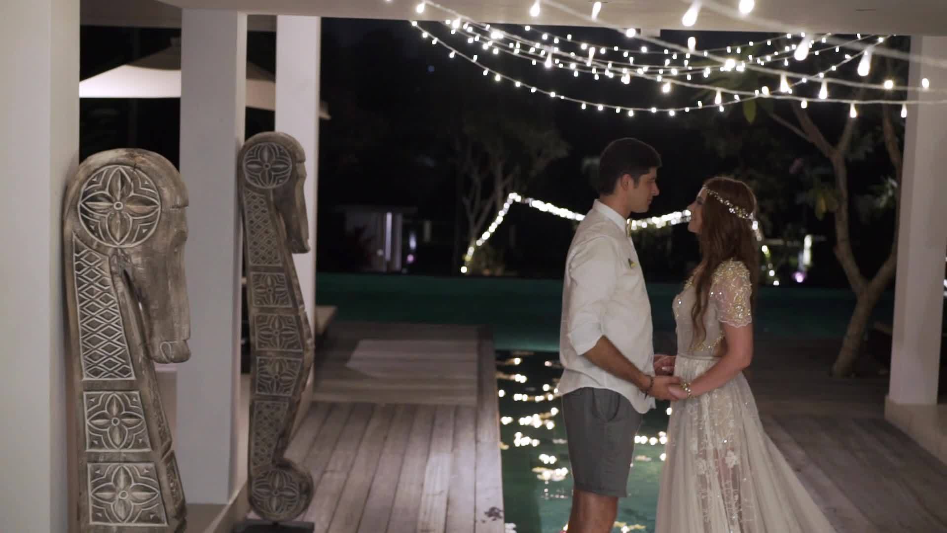 晚上拥抱和亲吻热带别墅里的新娘和新郎视频的预览图
