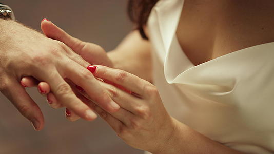 【不需要肖像权】婚礼上新娘把戒指戴在新郎的手指上视频的预览图