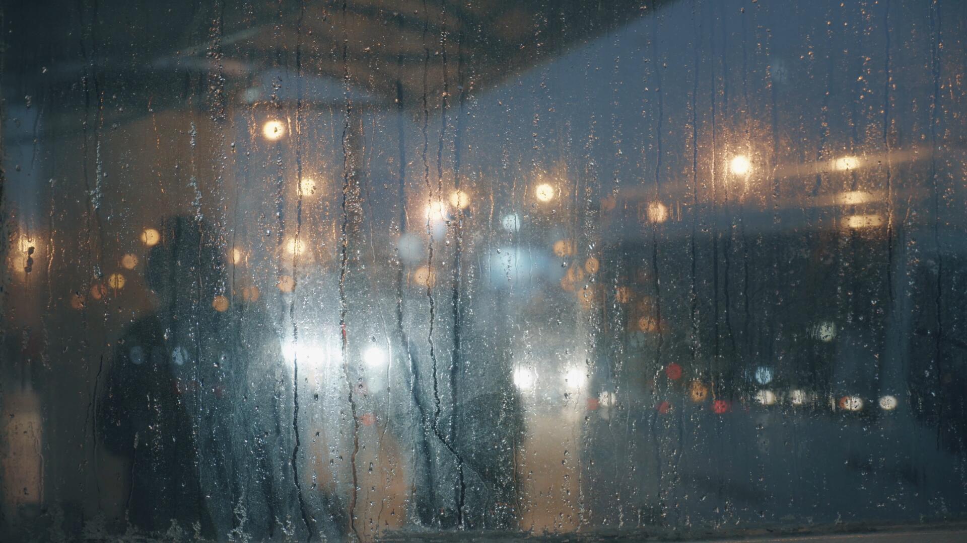 雨季夜晚公交车站台玻璃水珠视频的预览图