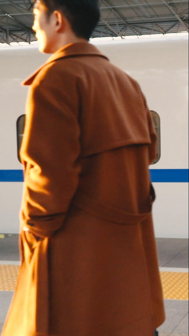 男青年推着行李箱在列车站台行走慢镜头视频的预览图
