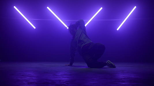 在紫外线下穿着街头服装跳嘻哈舞视频的预览图