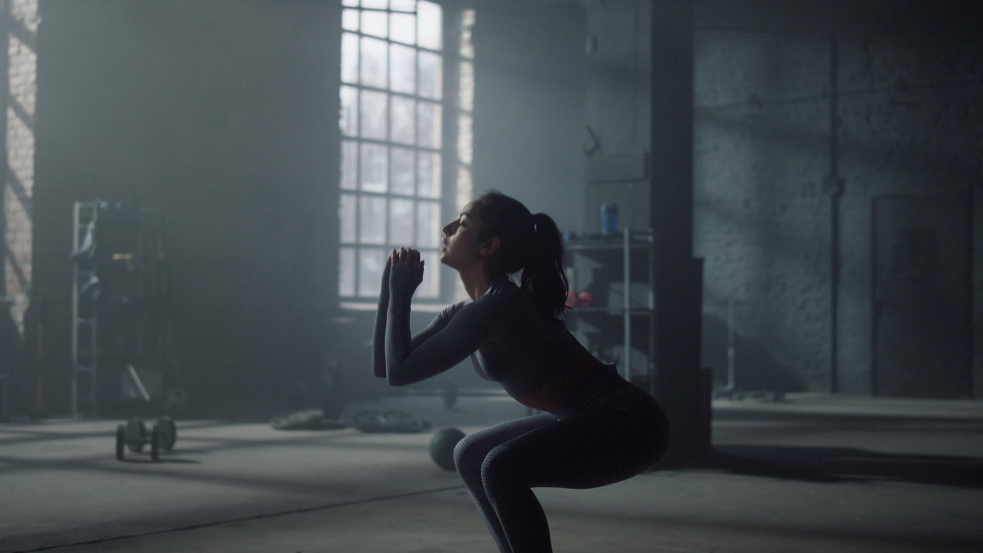女性健身房穿着运动服做深蹲跳跃视频的预览图