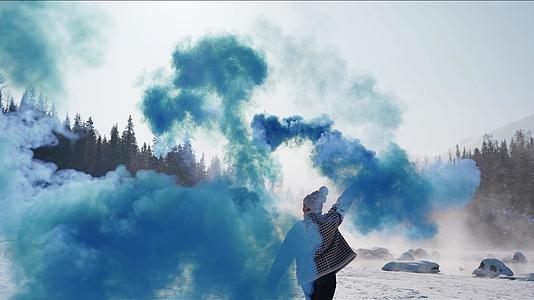 4K新疆一个人在雪地彩色烟雾视频的预览图