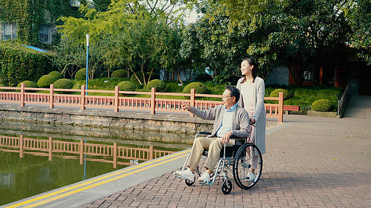 推坐轮椅的父亲逛公园视频的预览图