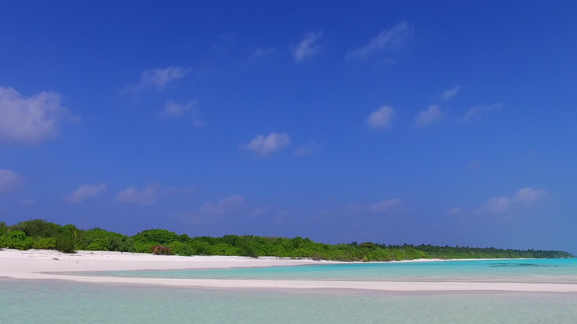 以阳光下白沙背景的浅礁湖为例探索宁静的海岸线和海滩视频的预览图