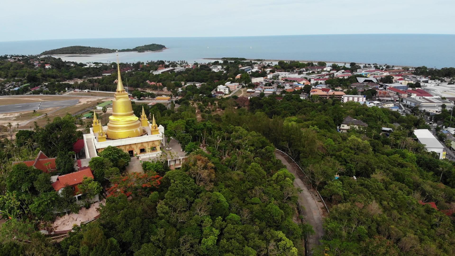 从无人机上方可以看到森林之间的经典佛教寺庙视频的预览图