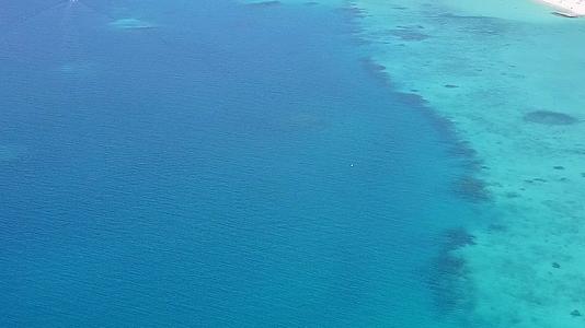 无人驾驶飞机在热带海岸线海滩航行以蓝海和白沙为背景视频的预览图