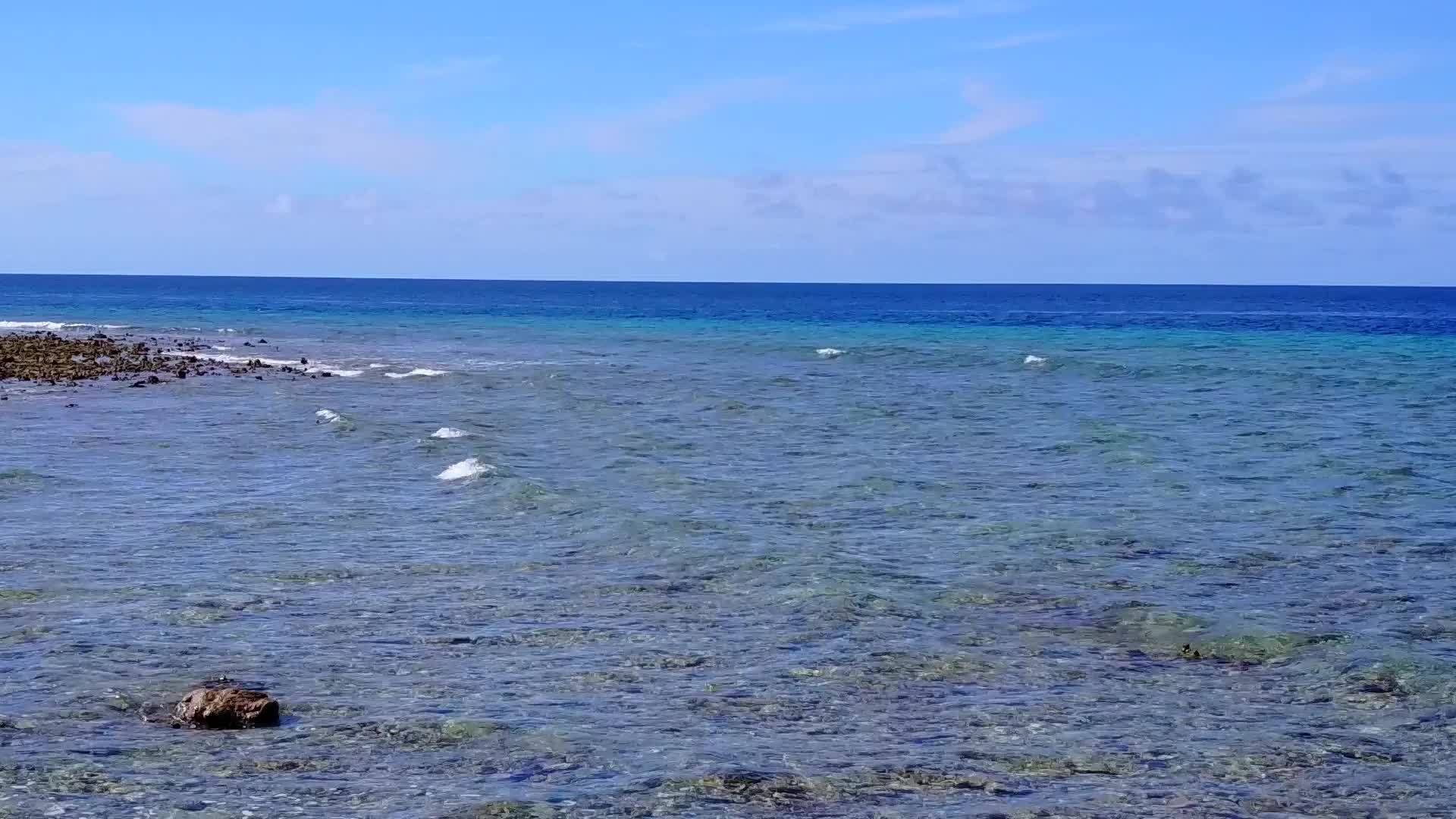 白色沙滩背景的蓝色环礁湖面向美丽的岛屿海滩之旅视频的预览图