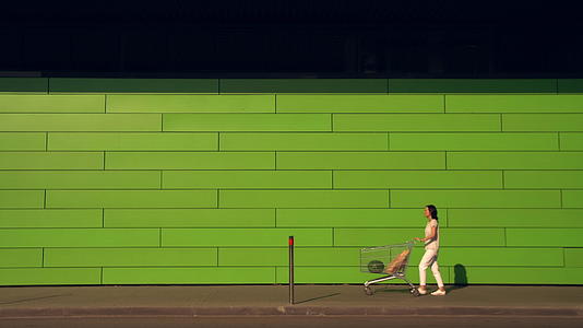 女人沿着绿墙走视频的预览图