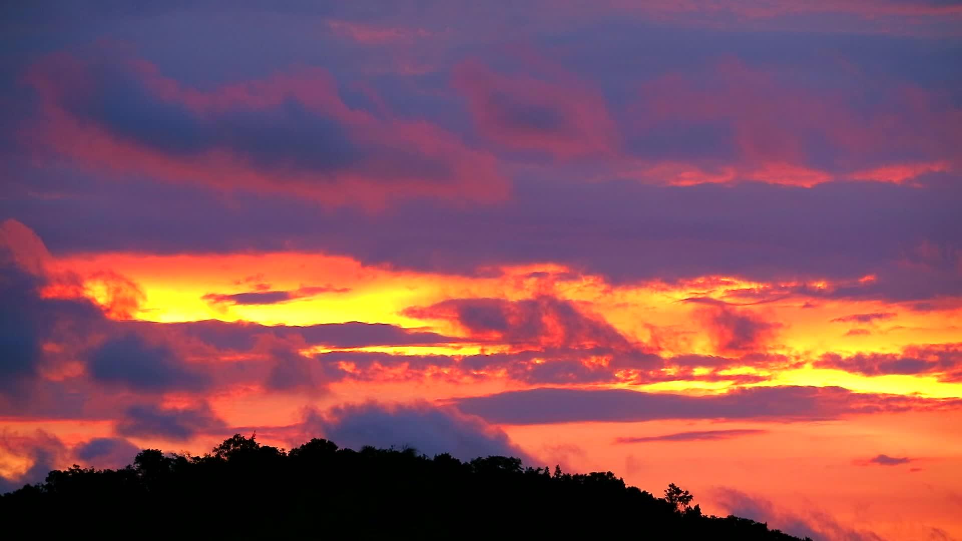 日落天空中的云移动穿过绿色的顶环影山1视频的预览图