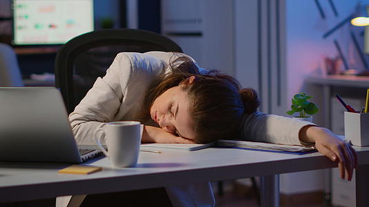 疲惫和超负荷的商业女商人睡在桌子上视频的预览图