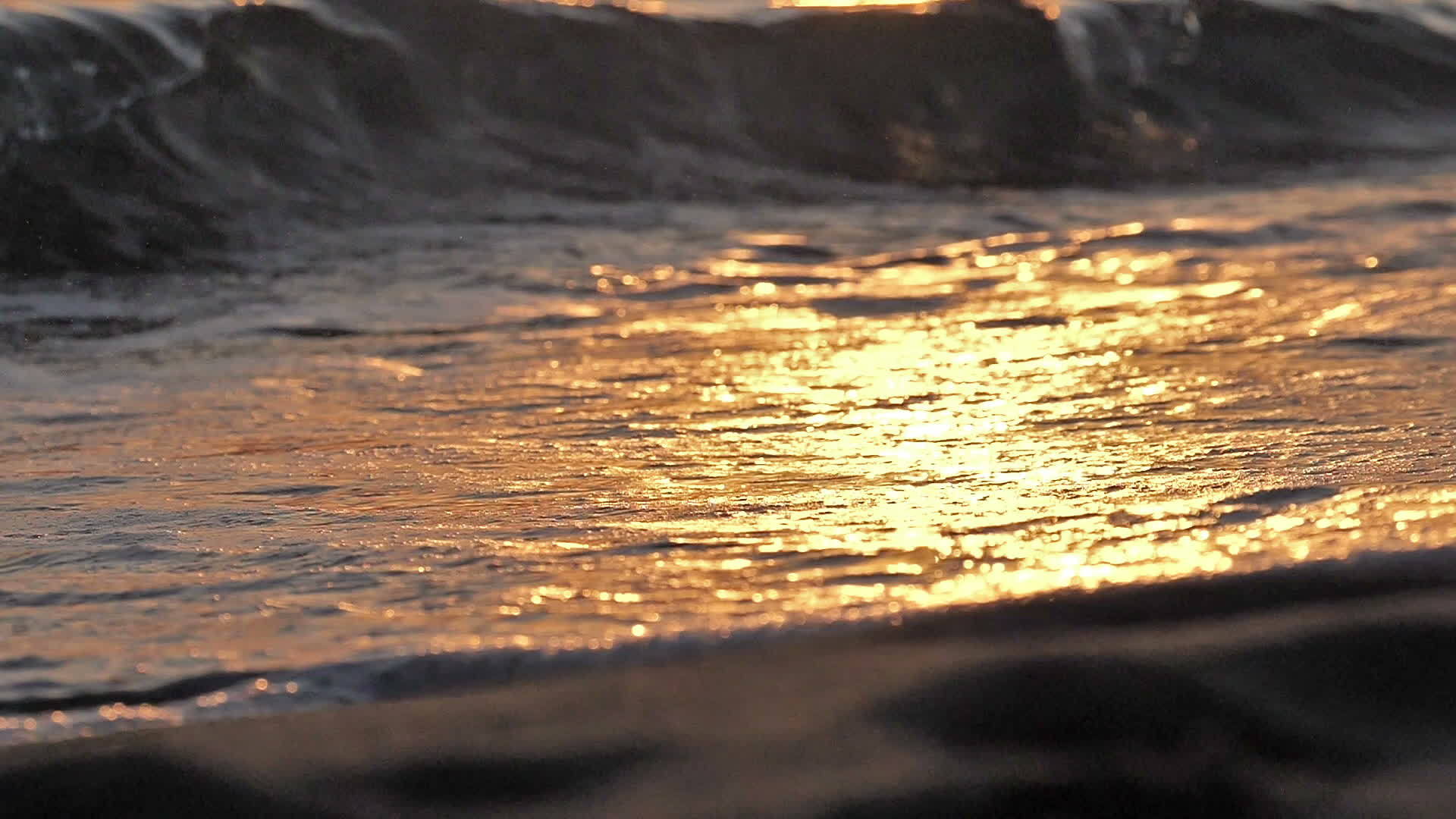 当日落缓慢时海滩上的海浪喷洒视频的预览图