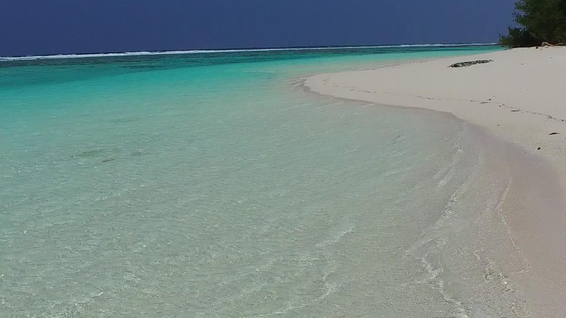 在蓝色泻湖和礁石附近的白色海滩的背景下美丽的海湾海滩度假胜地视频的预览图