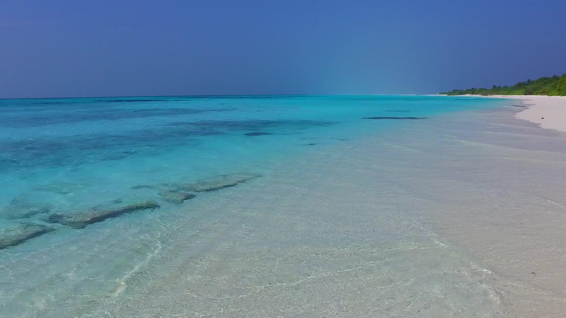 度假村附近蓝海和白沙背景的宁静海岸线海滩之旅视频的预览图