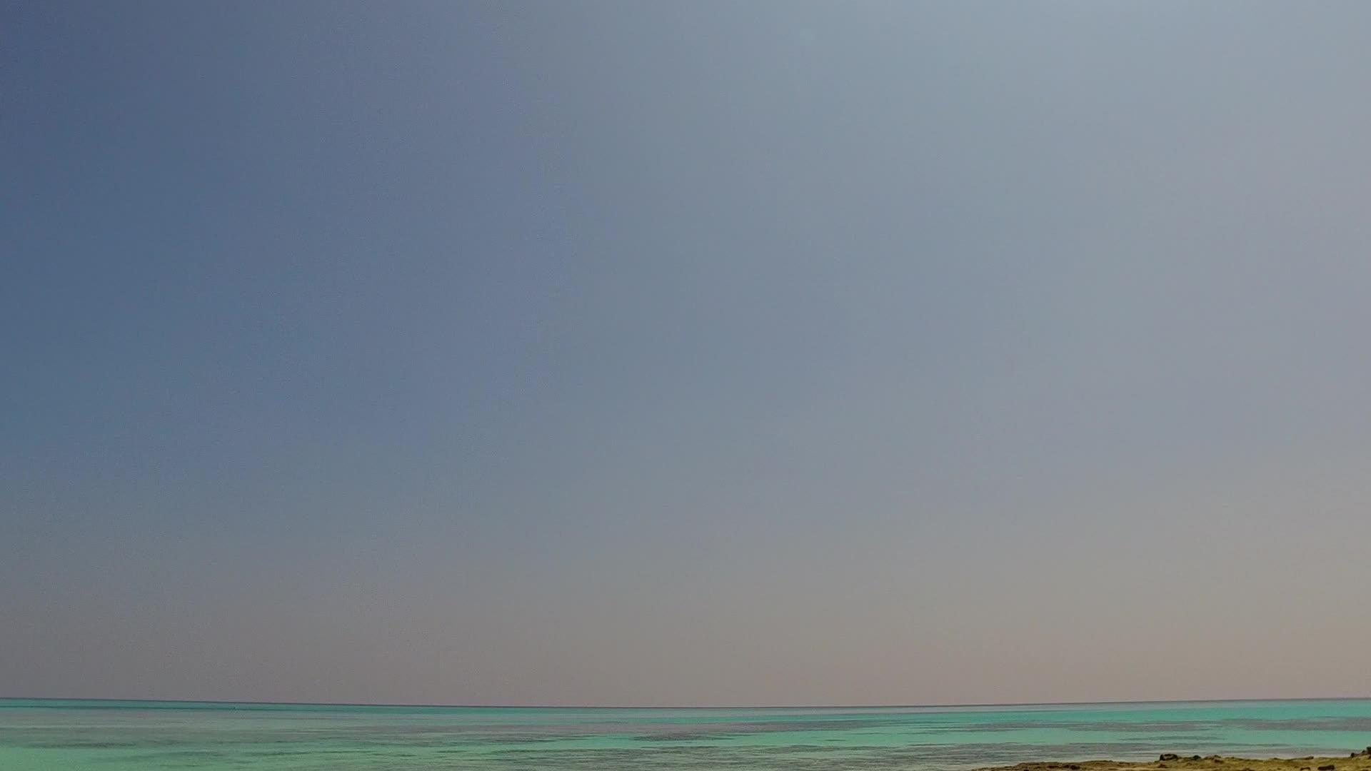 美丽的海湾海滩探险从海浪附近的白沙背景的绿水中冒出来视频的预览图