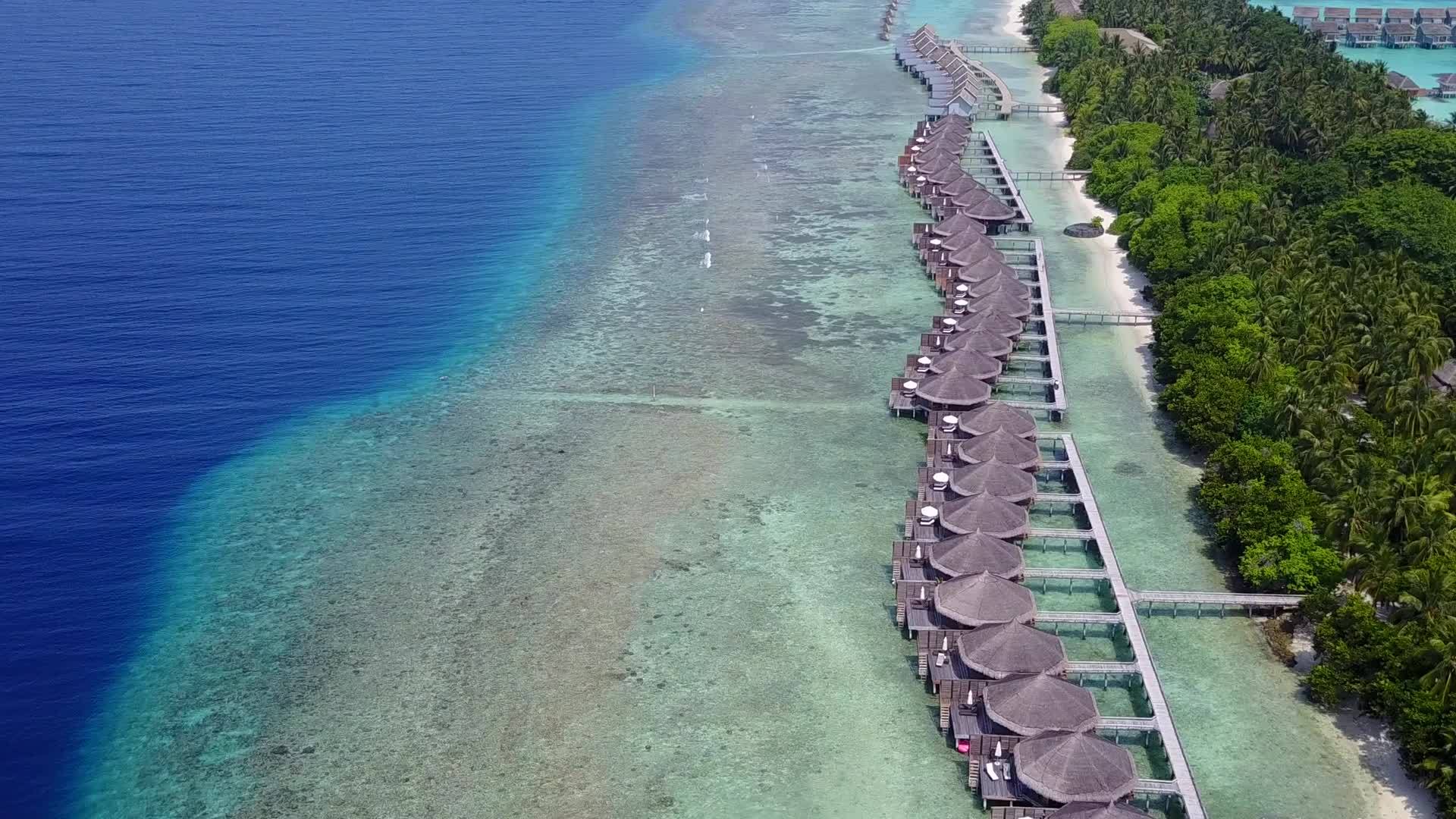 热带海岸海滩之旅蓝色泻湖和冲浪附近明亮的海滩背景视频的预览图