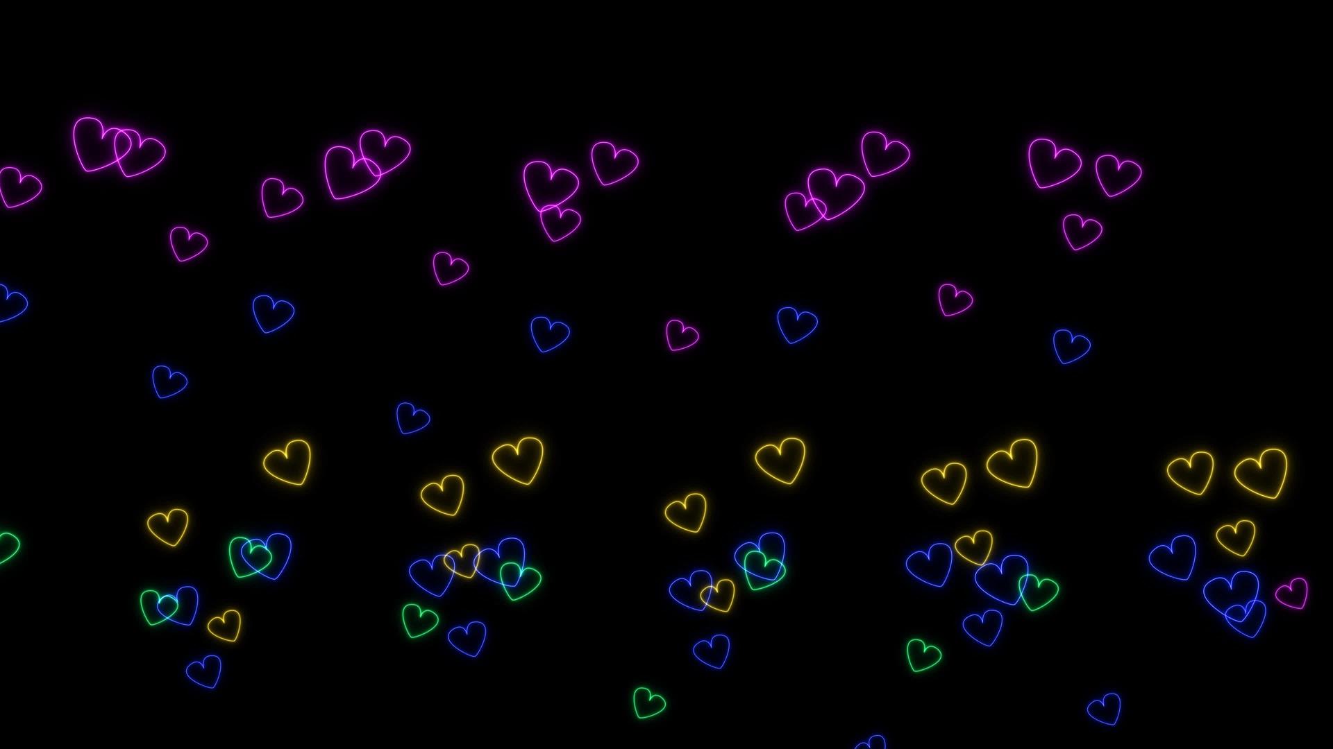 彩虹彩虹彩虹亮线塑造红心在黑屏上慢慢舞动视频的预览图