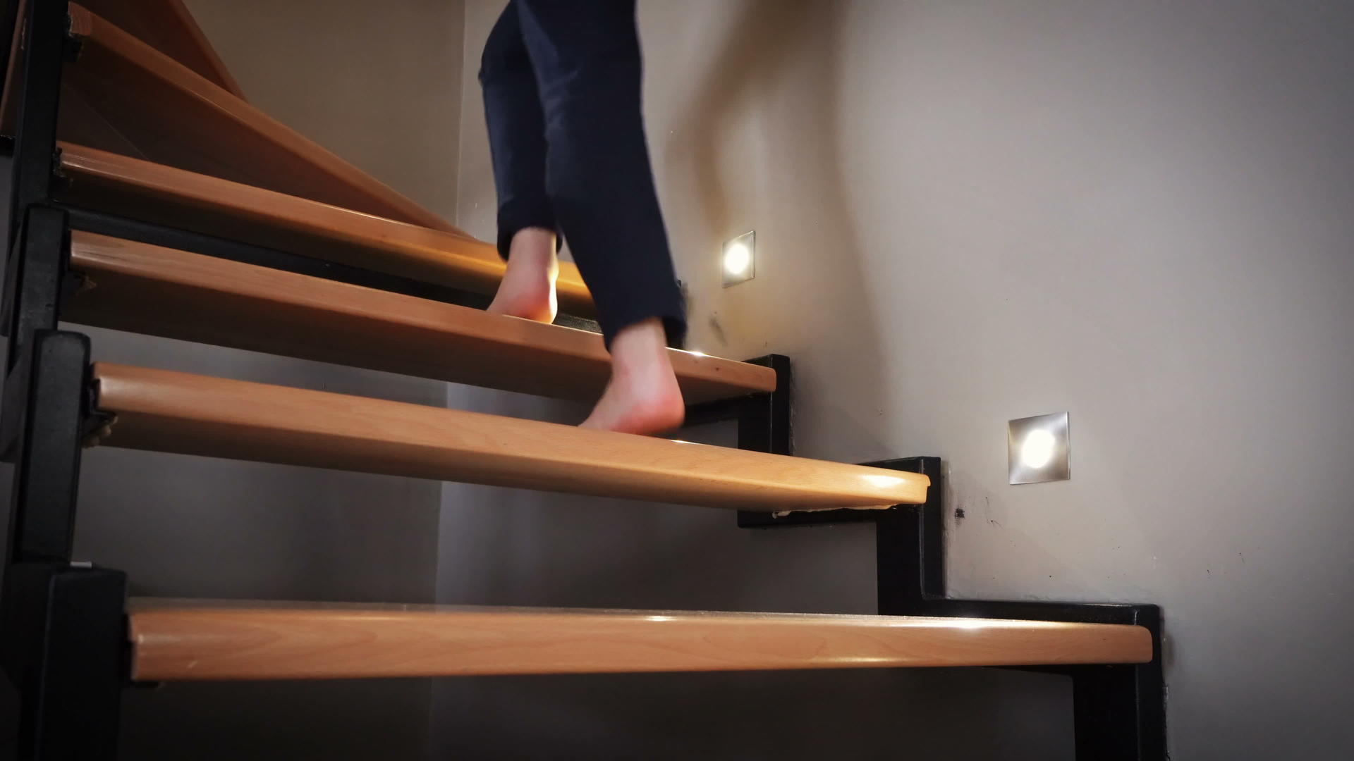 赤脚女人走在木制的现代室内木门室内楼梯上视频的预览图