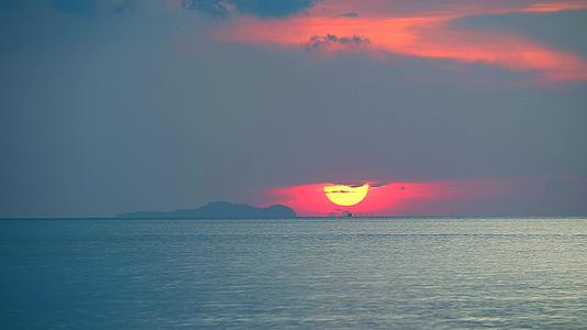 深红色的云彩橙色的天空和渔船在日落和黄昏时分视频的预览图