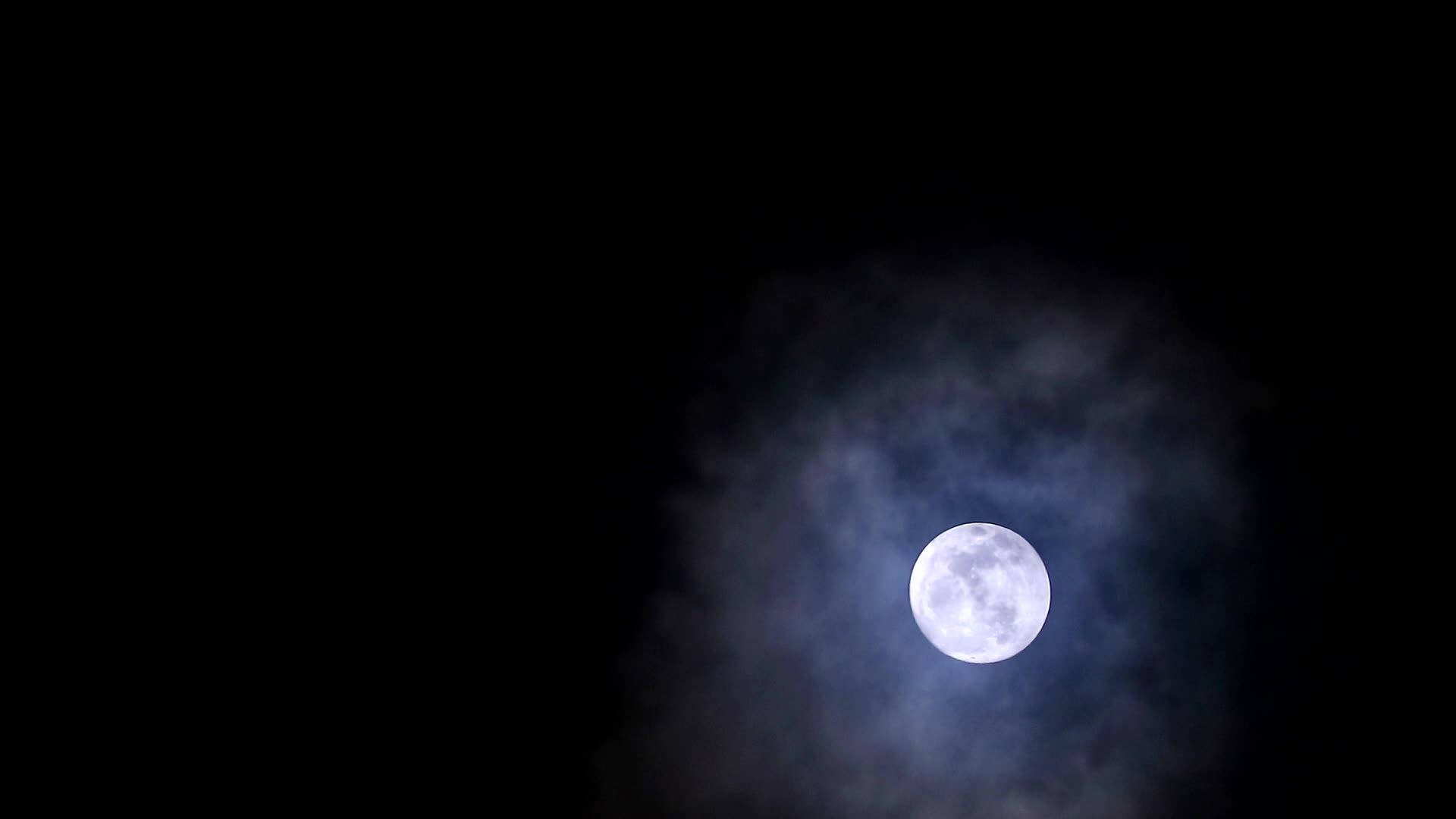 月亮在夜空和柔和的云流中视频的预览图