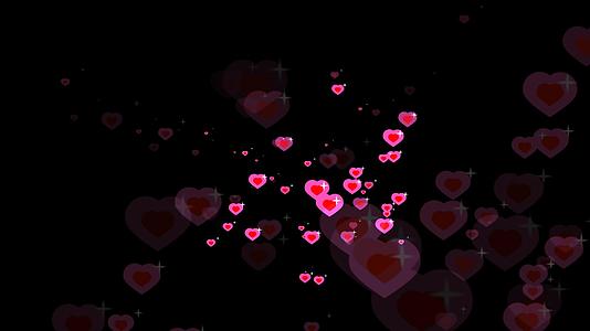 在粉色心脏主题的情人节和爱情卡片的模糊背景中红色的心和白星视频的预览图