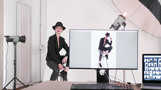 专业模特坐在椅子上向摄影师摆姿势视频的预览图