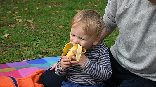 小男孩在小皮饼上吃香蕉视频的预览图