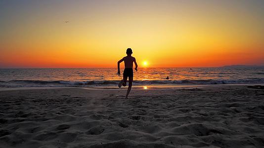 日落时分男孩们在海边奔跑跳入水中像电影一样慢慢摇摆视频的预览图