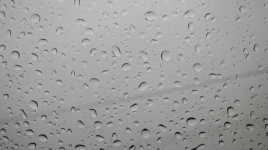 雨落在汽车的挡风玻璃上水滴在玻璃上雨天水在玻璃上视频的预览图