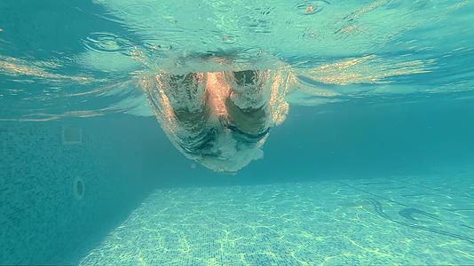 运动男子的头部在游泳池中跳跃水下风景中有巨大的飞溅和泡沫视频的预览图