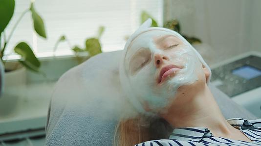 专业面部皮肤护理治疗在美容沙龙使用化妆蒸汽机视频的预览图