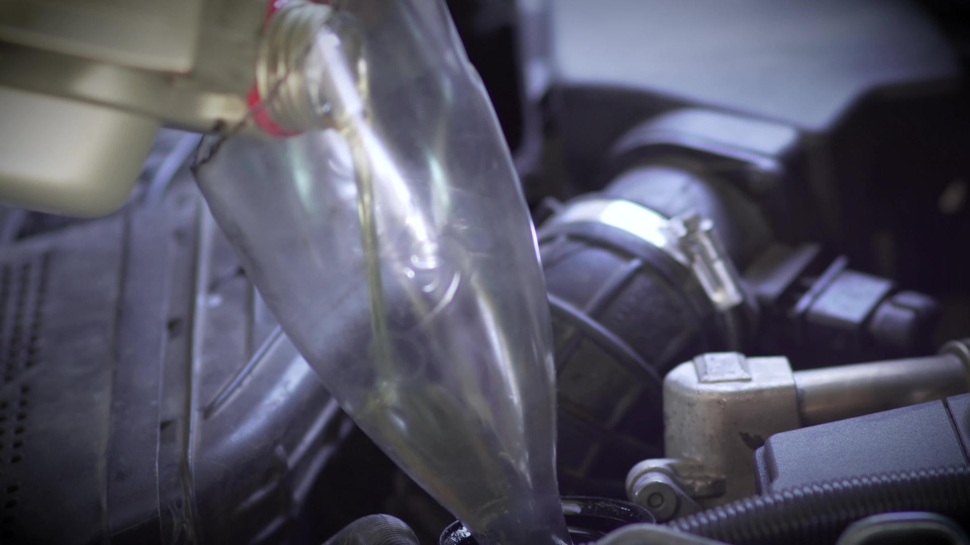 将新鲜清洁的合成油倒入汽车发动机中视频的预览图