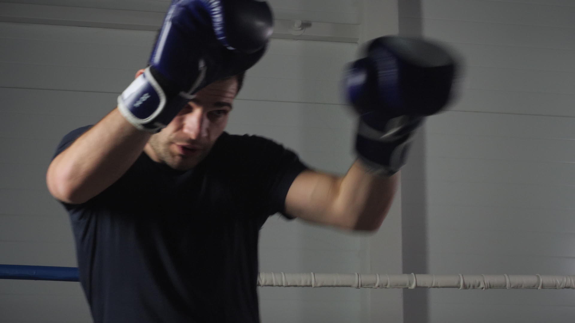 拳击手在戒指上的拳击场上与影子搏斗视频的预览图