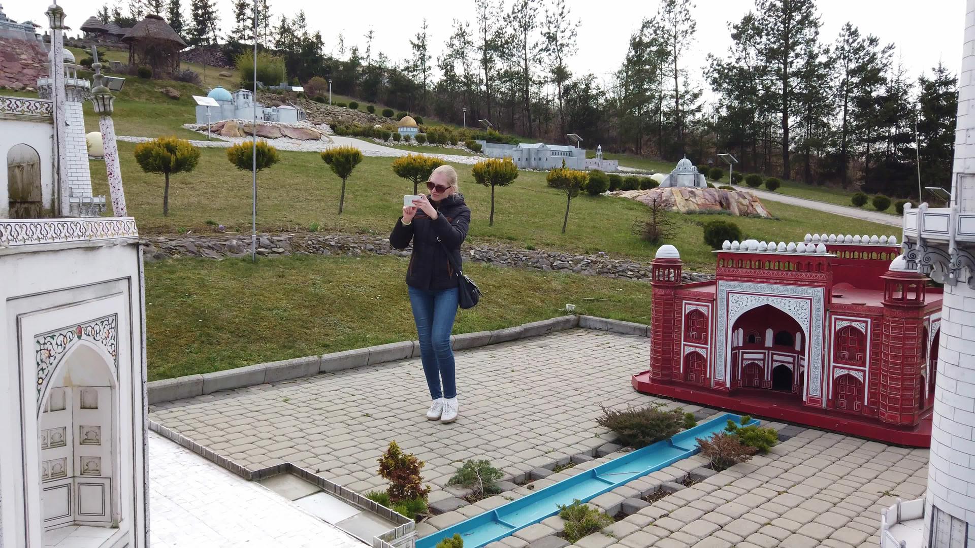 女性在TajMahal在迷你模型附近步行拍摄视频的预览图