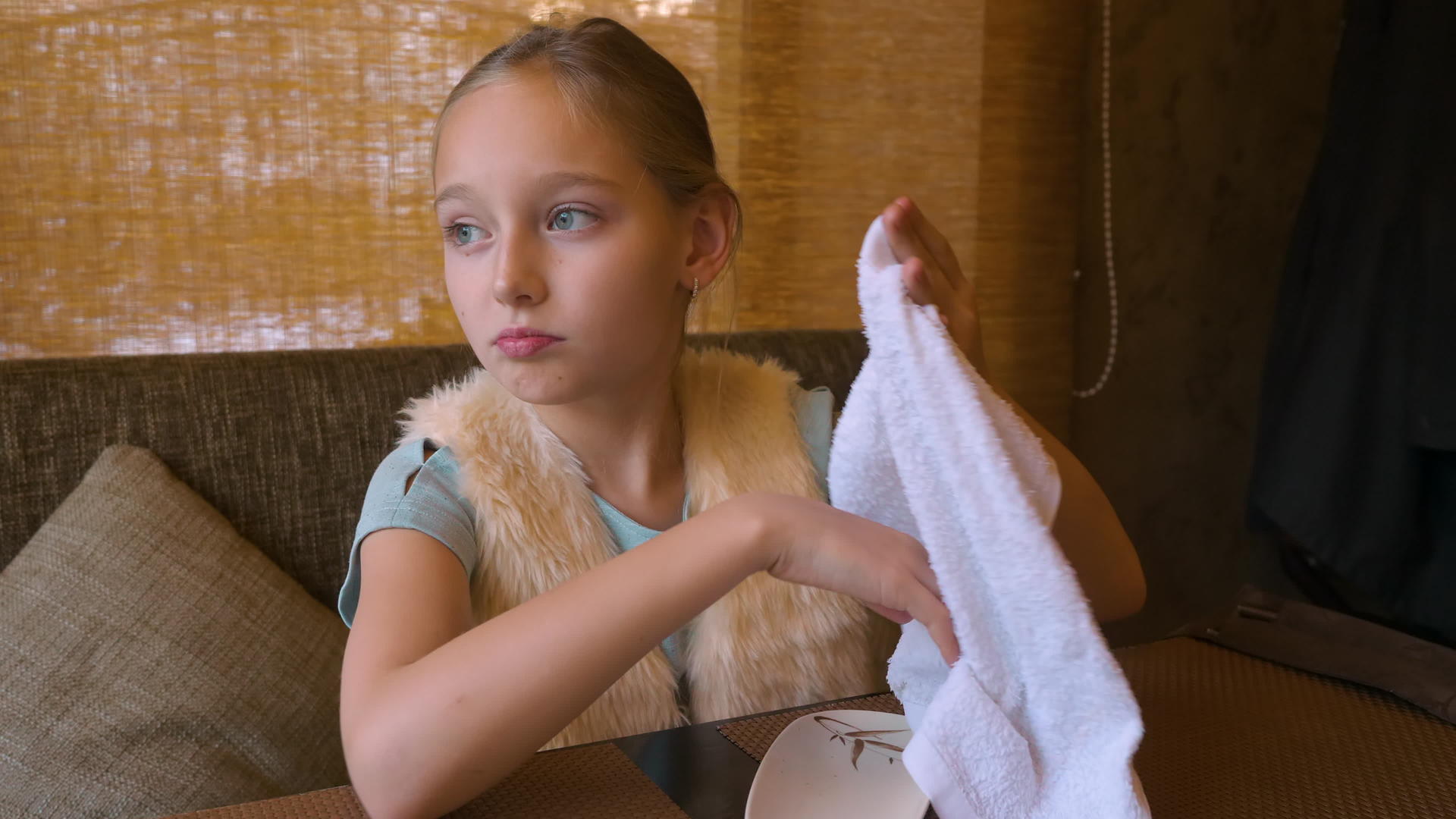 女孩坐在咖啡馆的桌子上用湿毛巾擦手吃寿司视频的预览图
