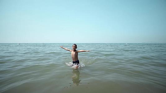 快乐的男孩从海里出海在电影院稳定的风景之前视频的预览图
