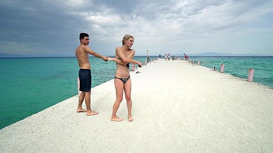 快乐浪漫的情侣在海滩码头微笑视频的预览图