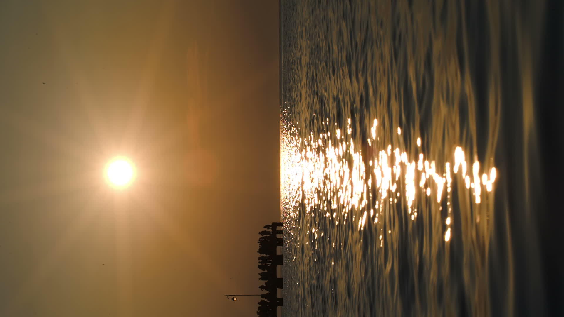 日落时人们在远处的码头上视频的预览图