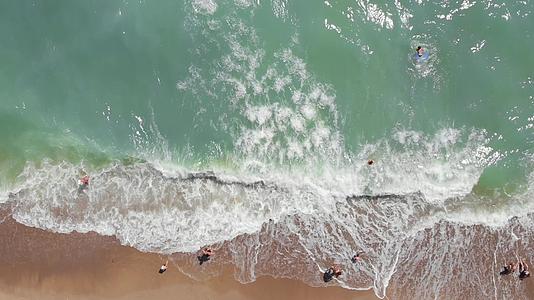 绿色的蓝水和泡沫海浪在沙滩上涌来；海浪在沙滩上视频的预览图