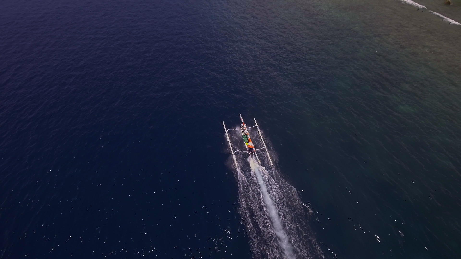 一艘渔船在蓝色的海水中从上到下看着一艘船视频的预览图