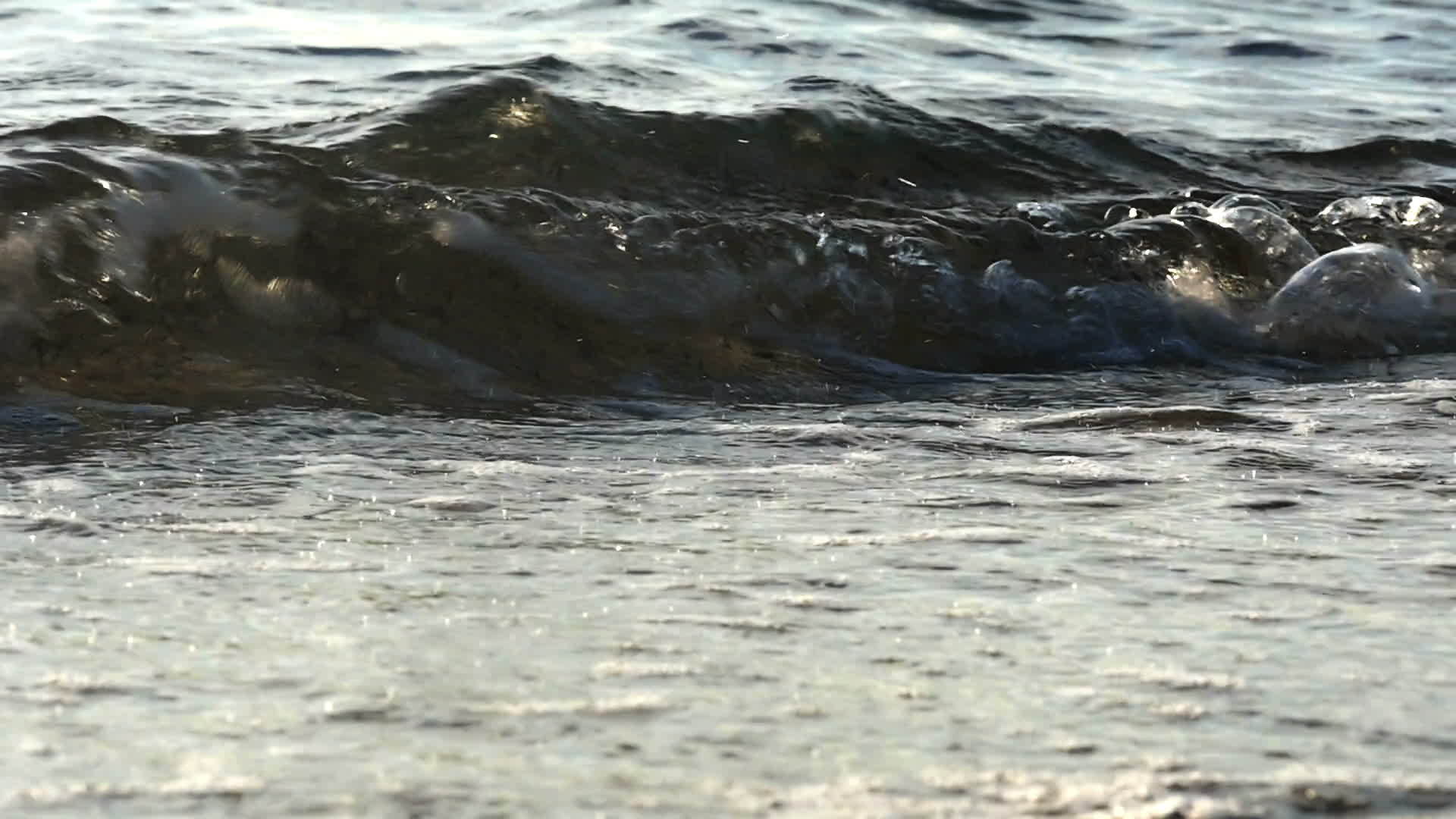 美丽的波浪在海滩上缓慢地移动视频的预览图
