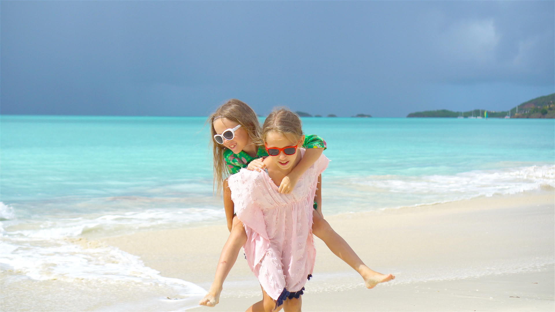在热带海滩玩得开心的小女孩一起玩慢动作视频的预览图