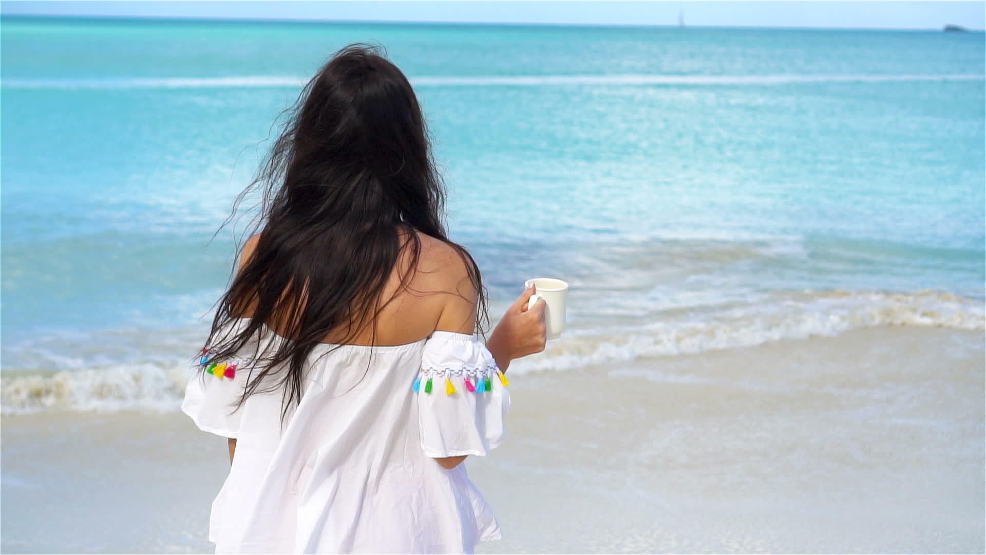 在白色热带海滩上喝热饮的年轻女孩享受美丽视频的预览图