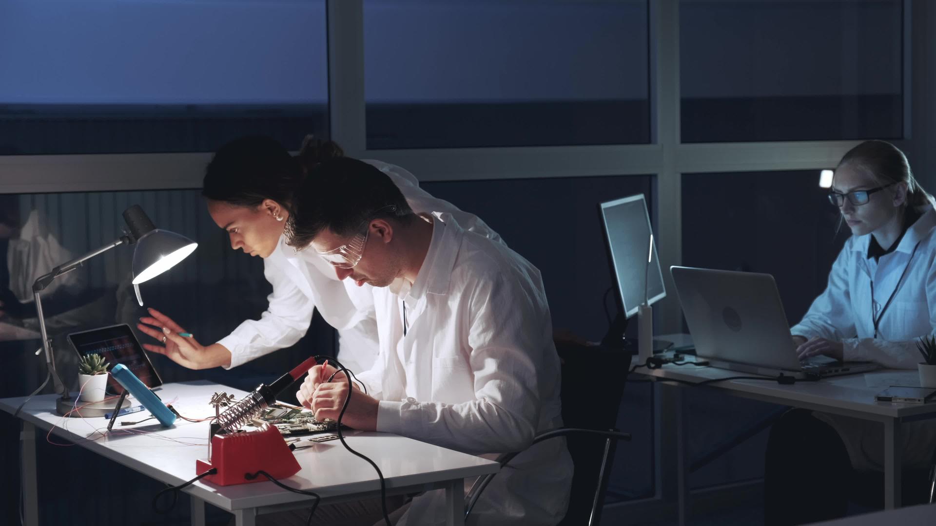 两名混合种族工程师使用多米测试仪检查主机板视频的预览图