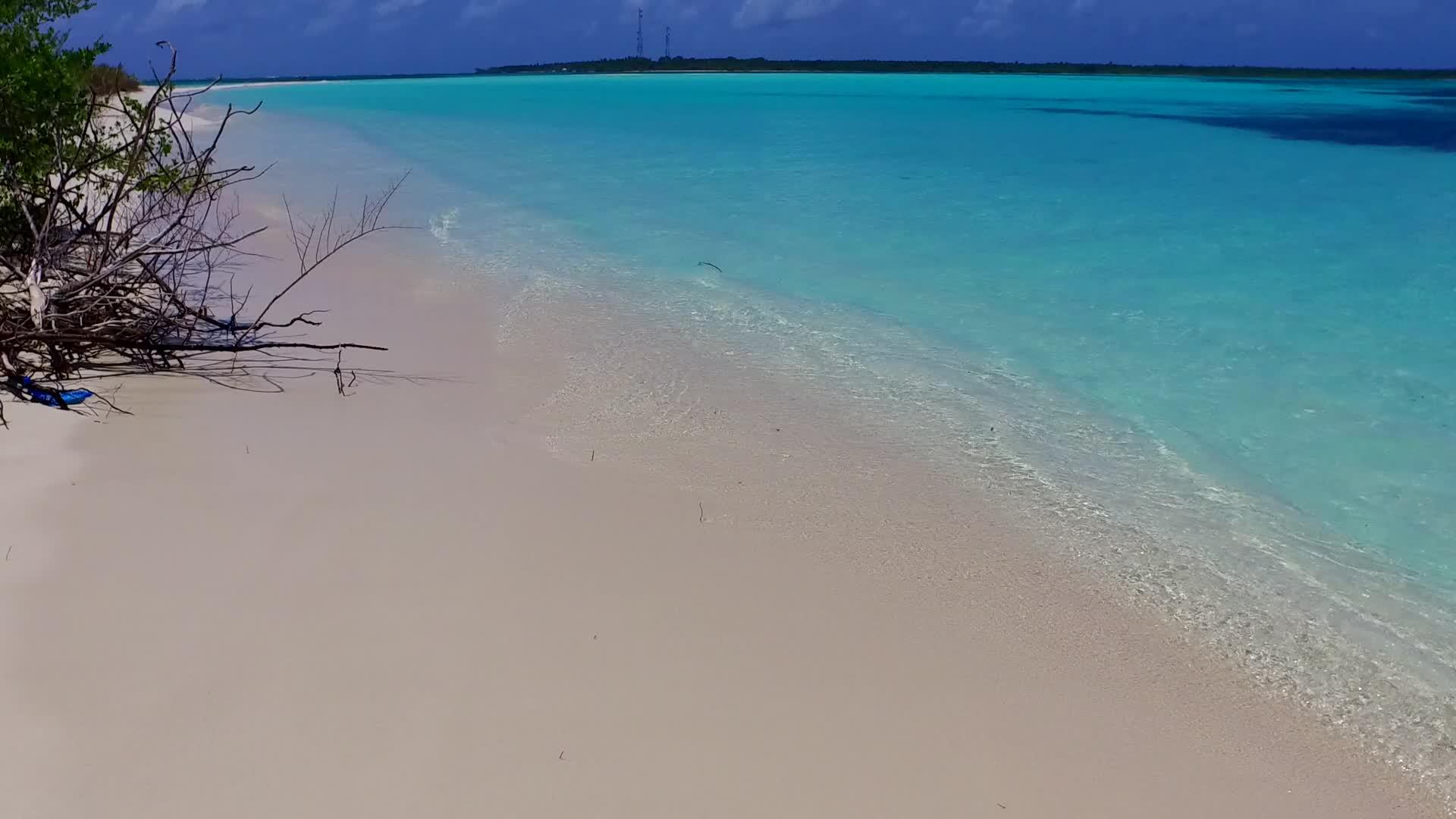 阳光明媚的海滩风景以白沙为背景在海浪附近视频的预览图