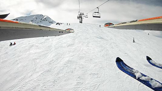 在阳光明媚的日子里跳过山上的滑雪坡和滑雪机视频的预览图