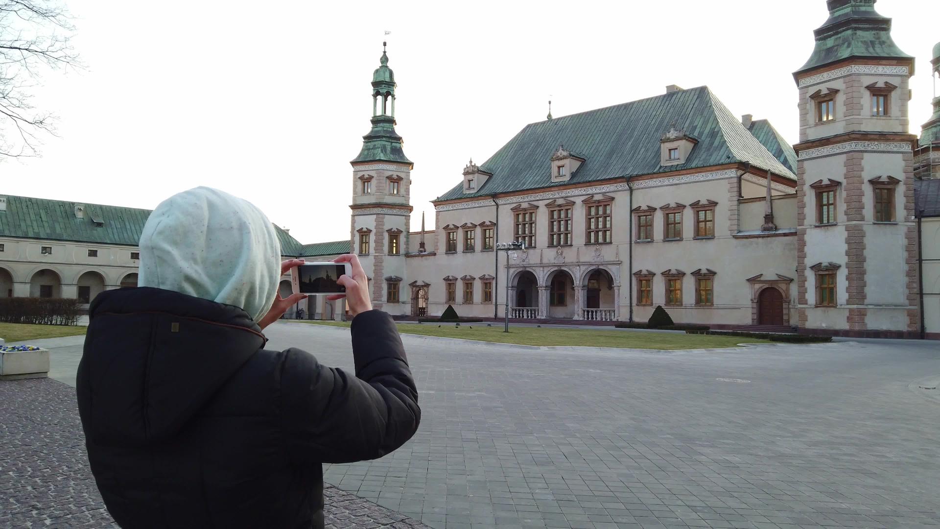 女游客拍摄旧宫殿的照片视频的预览图